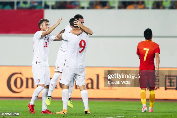 Aleksandar Mitrovic of Serbia celebrates with team mates after scoring his team's second goal during International Friendly Football Match between...