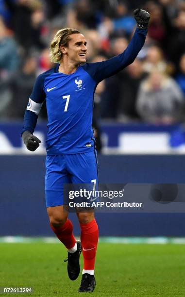 France's forward Antoine Griezmann celebrates after scoring a goal during the friendly football match between France and Wales at the Stade de France...