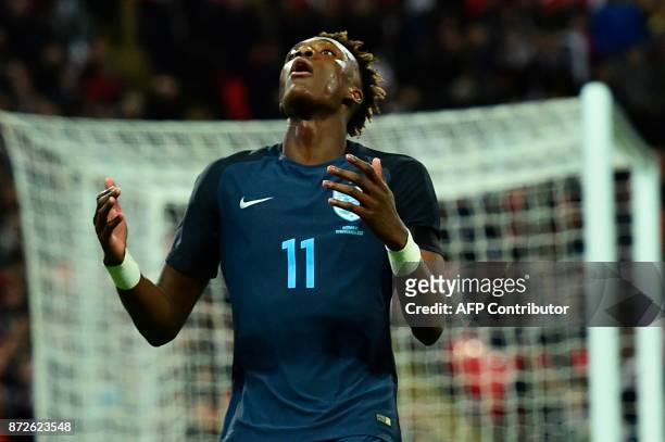 England's striker Tammy Abraham reacts after England's striker Jamie Vardy missed a chance during the friendly international football match between...