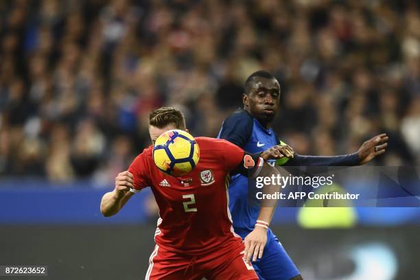 Wales' defender Chris Gunter vies for the ball with France's midfielder Blaise Matuidi during the friendly football match between France and Wales at...