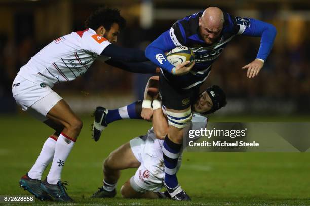 Matt Garvey of Bath is held up by Charlie Thacker of Leicester during the Anglo-Welsh Cup Round 2 match between Bath Rugby and Leicester Tigers at...