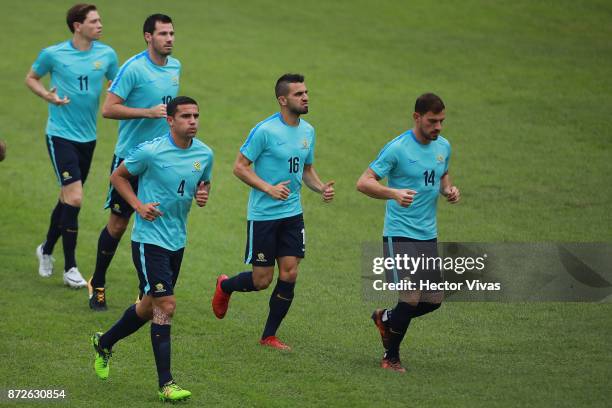 Tim Cahill, Alex Gersbach and James Troisi of Australia run during a training session ahead of the leg 1 of FIFA World Cup Qualifier Playoff against...