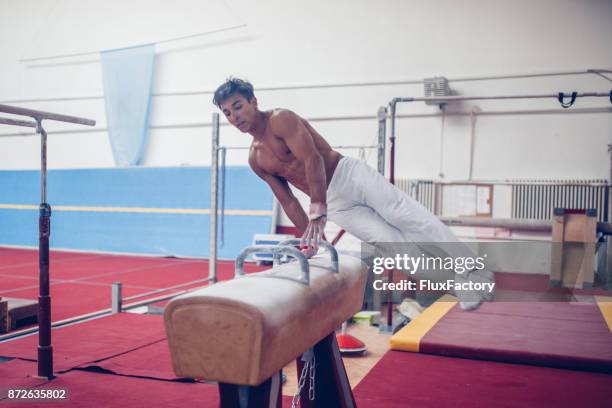 exercising on pommel horse - male gymnast stock pictures, royalty-free photos & images