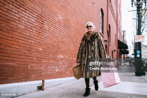 stylish and quirky senior woman - fur coat stock pictures, royalty-free photos & images