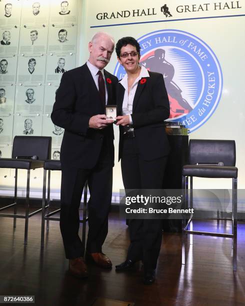 Chairman of the Hockey Hall of Fame Lanny McDonald presents Danielle Goyette with the Hall ring during a media opportunity at the Hockey Hall Of Fame...