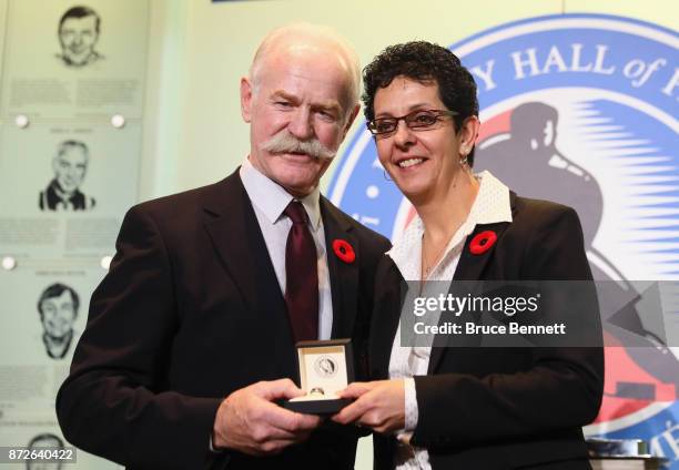 Chairman of the Hockey Hall of Fame Lanny McDonald presents Danielle Goyette with the Hall ring during a media opportunity at the Hockey Hall Of Fame...