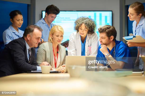 business and medicine meet - medical administrator stock pictures, royalty-free photos & images