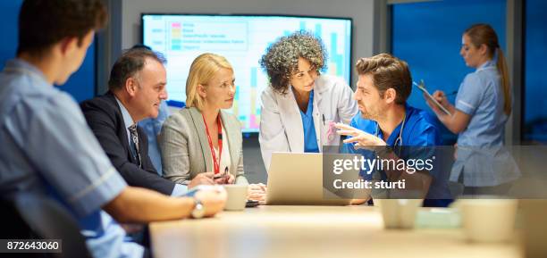hospital management listening to doctor - nurse manager stock pictures, royalty-free photos & images