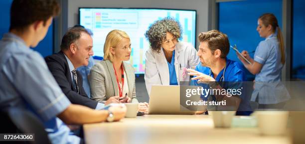 hospital management listening to doctor - hospital teamwork stock pictures, royalty-free photos & images