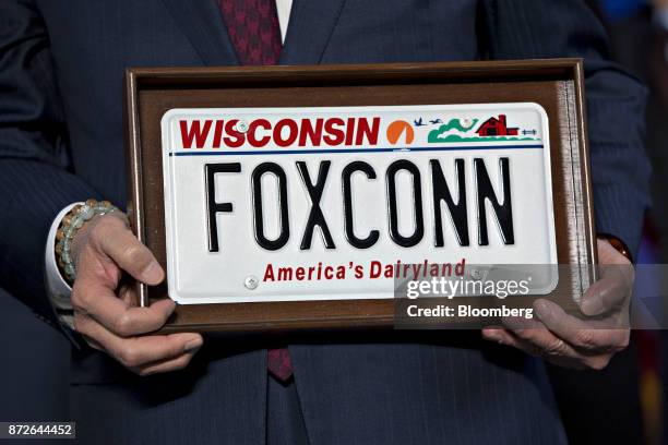 Billionaire Terry Gou, chairman of Foxconn Technology Group, holds a "FOXCONN" Wisconsin license plate during an event in Racine, Wisconsin, U.S., on...