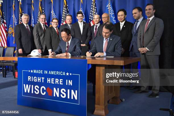 Scott Walker, governor of Wisconsin, right, and Billionaire Terry Gou, chairman of Foxconn Technology Group, left, sign an Electronics and...