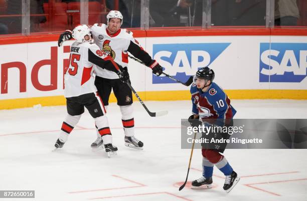 Mark Stone of the Ottawa Senators celebrates his overtime game-winning goal with Matt Duchene as Sven Andrighetto of the Colorado Avalanche skates...