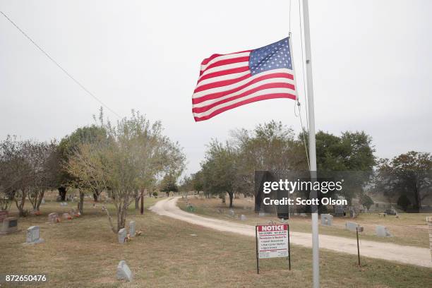 Flag flies at half mast outside the Sutherland Springs Cemetery on November 10, 2017 in Sutherland Springs, Texas. Tomorrow the first victimis of the...