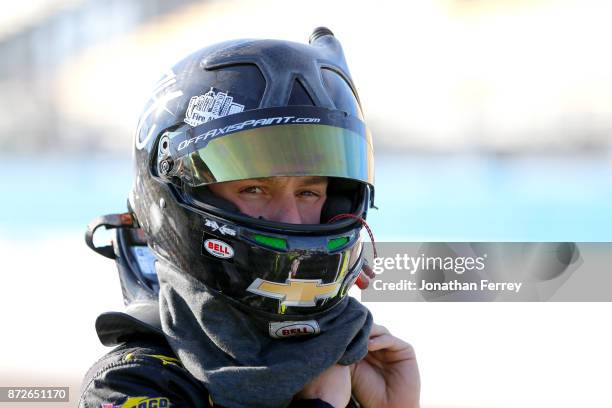 John H. Nemechek, driver of the Fire Alarm Services Inc. Chevrolet, gets into his car during qualifying for the NASCAR Camping World Truck Series...