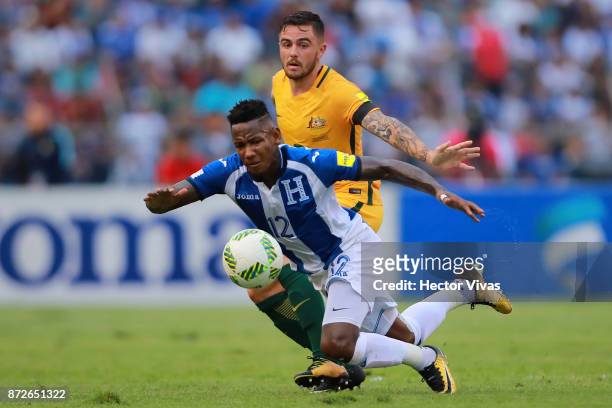 Joshua Risdon of Australia struggles for the ball with Romell Quioto of Honduras during a first leg match between Honduras and Australia as part of...