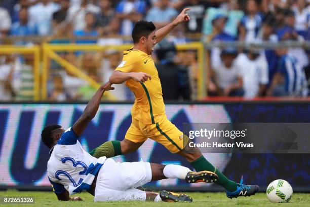 Massimo Luongo of Australia struggles for the ball with Johnny Palacios of Honduras during a first leg match between Honduras and Australia as part...