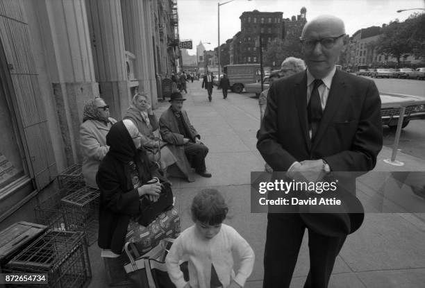 Yiddish writer and journalist for The Jewish Daily Forward Isaac Bashevis Singer poses for a portrait on East Broadway near the Forward Building in...
