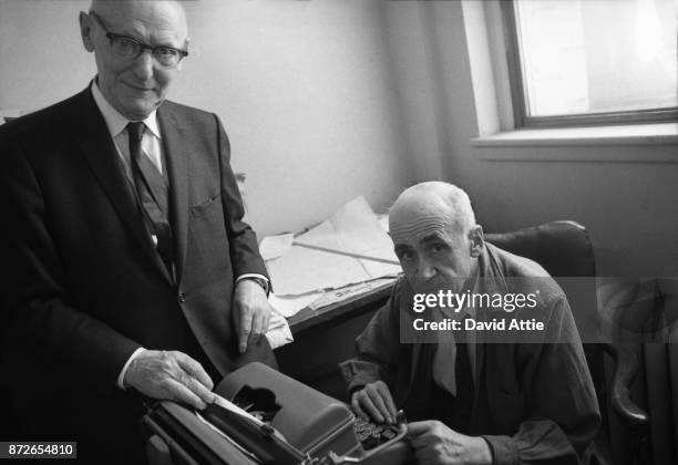 Yiddish writer and journalist for The Jewish Daily Forward Isaac Bashevis Singer poses for a portrait with co-worker and poet Maurice Winograd in the...