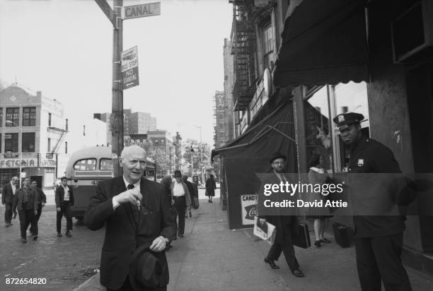 Yiddish writer and journalist for The Jewish Daily Forward Isaac Bashevis Singer poses for a portrait at the intersection of Canal and Rutgers...