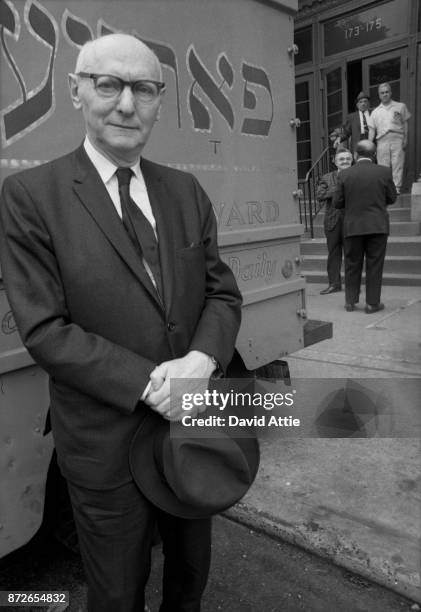 Yiddish writer and journalist for The Jewish Daily Forward Isaac Bashevis Singer poses for a portrait outside the Forward Building in the Lower east...