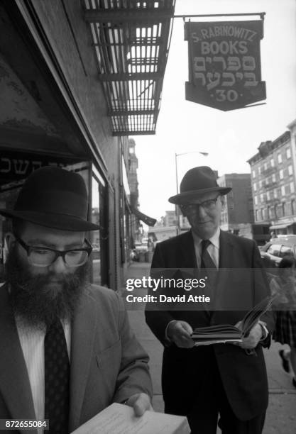 Yiddish writer and journalist for The Jewish Daily Forward Isaac Bashevis Singer poses for a portrait outside the S. Rabinowitz Hebrew Book Store at...