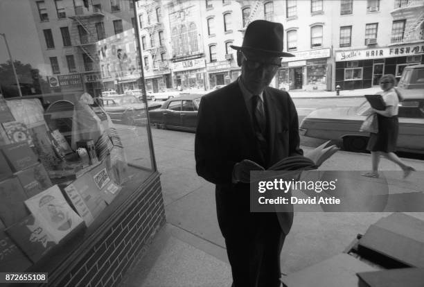 Yiddish writer and journalist for The Jewish Daily Forward Isaac Bashevis Singer poses for a portrait outside the S. Rabinowitz Hebrew Book Store at...