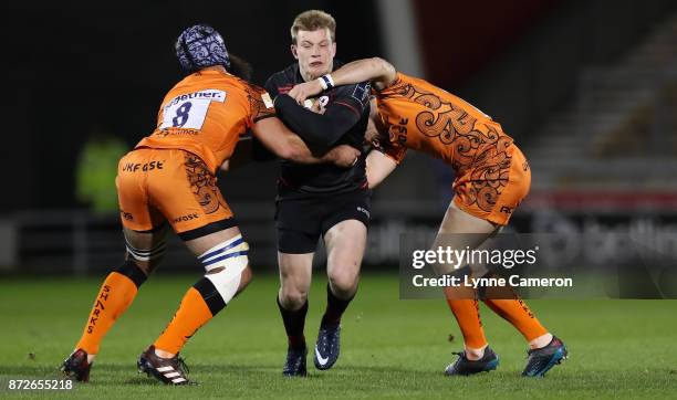 Josh Strauss and AJ MacGinty of Sale Sharks tackle Cameron Redpath of Sale Sharks during the Anglo-Welsh Cup match between Sale Sharks and Saracens...