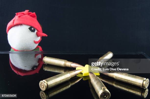 snowman observing bullets - machine christmas tree stock pictures, royalty-free photos & images