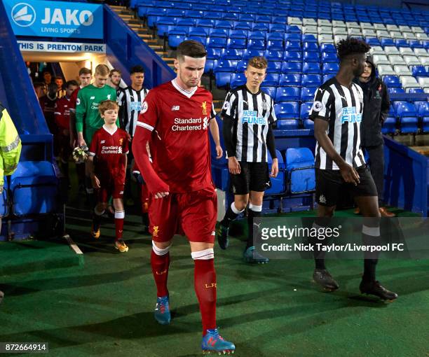 Corey Whelan of Liverpool and Mo Sangare of Newcastle United make their way to the pitch at the start of the Liverpool U23 v Newcastle United U23...