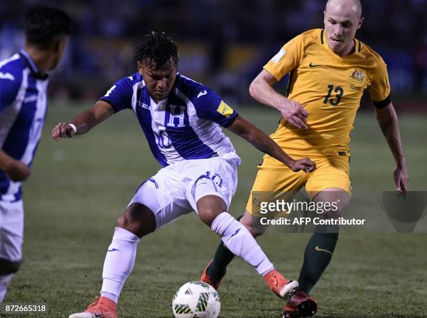 Honduras' Mario Martinez is marked by Australia's Aaron Mooy during the first leg football match of their 2018 World Cup qualifying play-off in San...