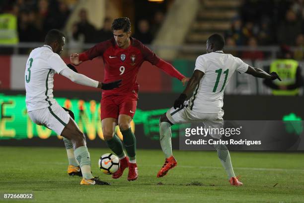 Portugal forward Andre Silva vies with Saudi Arabia defender Osama Hawsawi and Saudi Arabia midfielder Abdulmalek Al Khaibri for the ball possession...