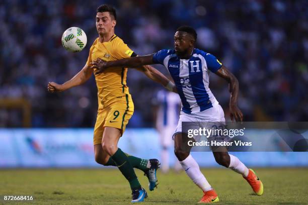 Tomi Juric of Australia struggles for the ball with Johnny Palacios of Honduras during a first leg match between Honduras and Australia as part of...