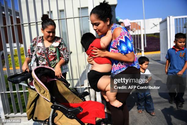 Isabel Pantoja holds her ten-month-old baby Luis Gonzales as they arrive at a clinic in Colima city for Luis' medical check-up, in Mexico on November...