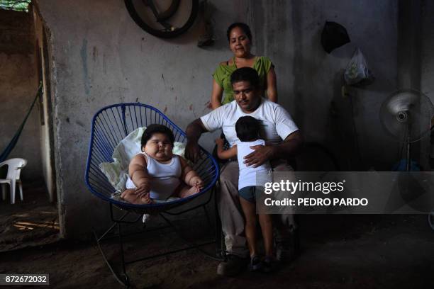 Ten-month-old Luis Gonzales is pictured with his parents Isabel Pantoja and Mario Gonzales, and his elder brother Mario at their home in Tecoman,...