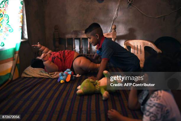 Ten-month-old Luis Gonzales is pictured with his cousin Michel and his brother Mario at his home in Tecoman, Colima state, Mexico on November 8,...