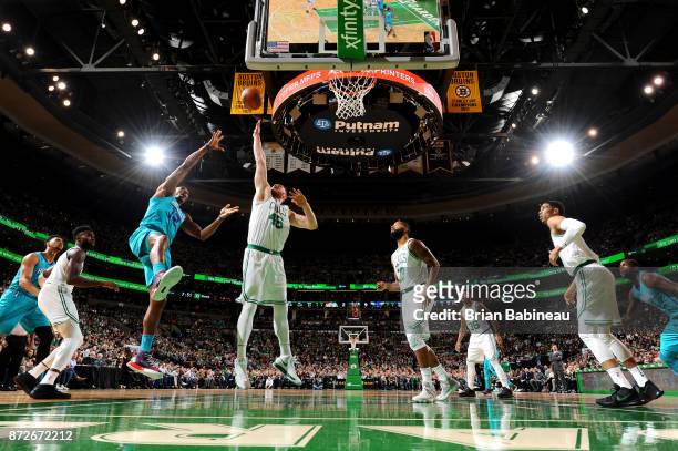 Aron Baynes of the Boston Celtics jumps to block the shot from Dwight Howard of the Charlotte Hornets on November 10, 2017 at the TD Garden in...