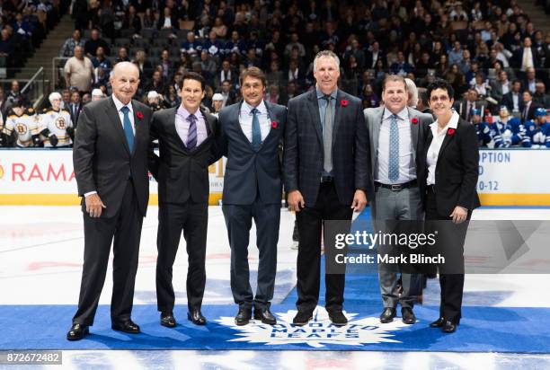 Newly elected Hockey Hall of Fame members Jeremy Jacobs, Paul Kariya, Teemu Selanne, Dave Andreychuk, Mark Recchi, and Danielle Goyette stand at...