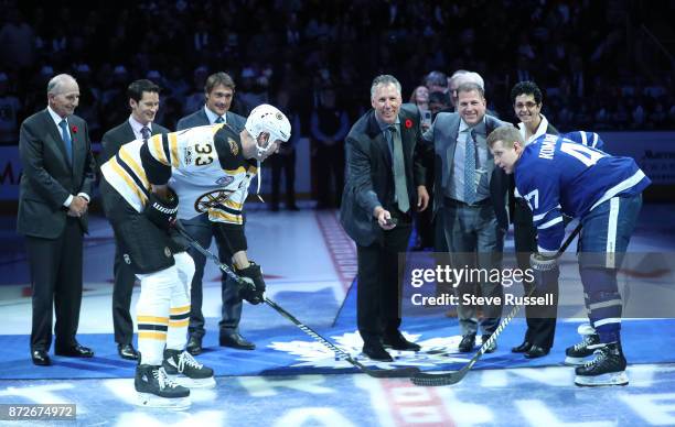 Members of the 2017 Hall of Fame Class drop the ceremonial face off as the Toronto Maple Leafs play the Boston Bruins at BMO Field in Toronto....