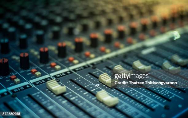 microphone over the abstract blurred on sound mixer out of focus background - radio fotografías e imágenes de stock
