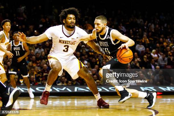 Upstate Spartans guard Pat Welch dribbles while Minnesota Golden Gophers forward Jordan Murphy defends during the regular season game between the USC...