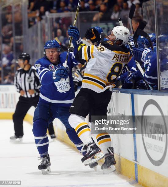 Morgan Rielly of the Toronto Maple Leafs hits David Pastrnak of the Boston Bruins during the second period at the Air Canada Centre on November 10,...