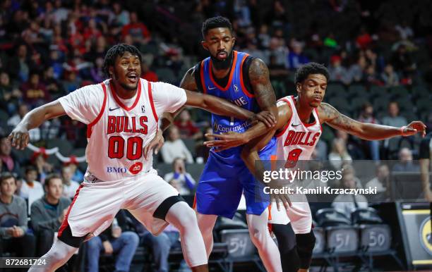 Diamond Stone and Jarell Eddie of the Windy City Bulls defend against Mike Cobbins of the Oklahoma City Blue during the first quarter of an NBA...