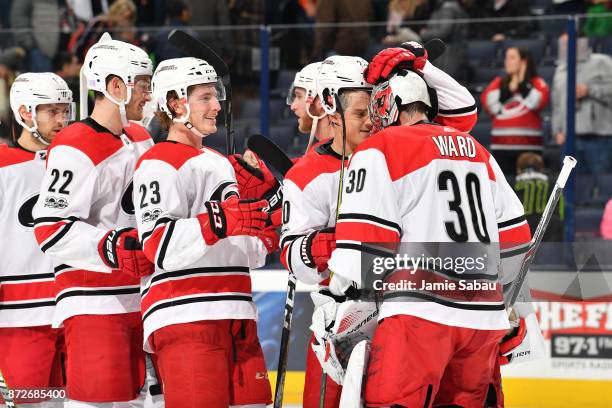 The Carolina Hurricanes celebrate with goaltender Cam Ward of the Carolina Hurricanes after defeating the Columbus Blue Jackets 3-1 in a game on...