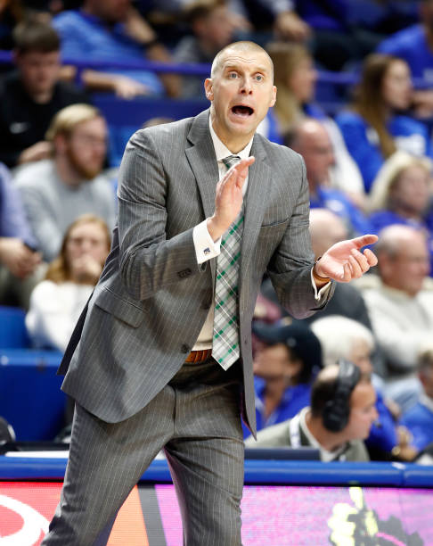 Mark Pope the head coach of the Utah Valley Wolverines gives instructions to his team in the game against the Kentucky Wildcats at Rupp Arena on...