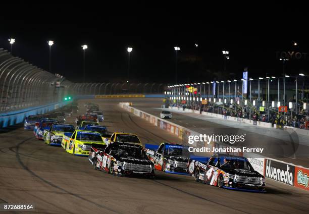 Christopher Bell, driver of the Toyota Toyota, and Noah Gragson, driver of the Switch Toyota, lead the field to start the NASCAR Camping World Truck...