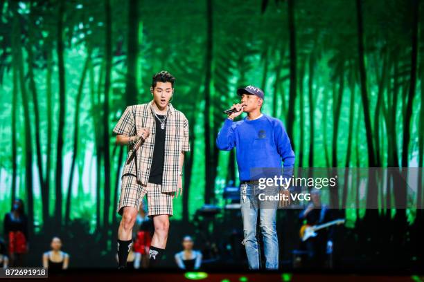 Singers Kris Wu and Pharrell Williams perform on the stage during 2017 Alibaba Singles' Day Global Shopping Festival gala at Mercedes-Benz Arena on...