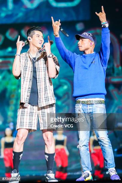 Singers Kris Wu and Pharrell Williams perform on the stage during 2017 Alibaba Singles' Day Global Shopping Festival gala at Mercedes-Benz Arena on...