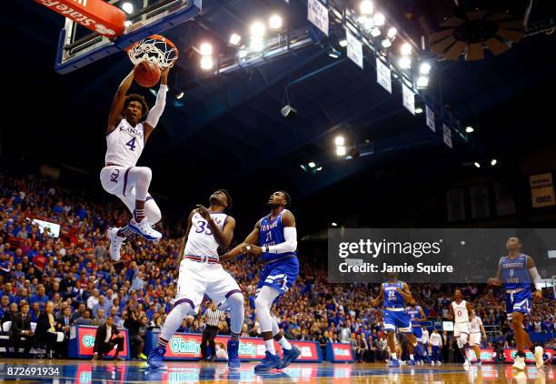 Devonte' Graham of the Kansas Jayhawks dunks on a fast break during the game against the Tennessee State Tigers at Allen Fieldhouse on November 10,...