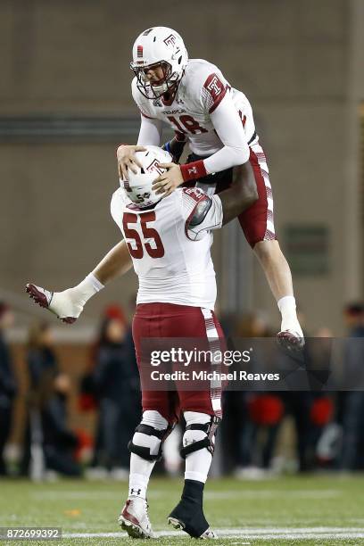 Frank Nutile of the Temple Owls celebrates with Brian Carter after throwing a touchdown against the Cincinnati Bearcats during the second half at...