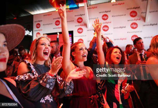 Olympia Valance dances as Natalie Bassingthwaighte performs at the Sensis Marquee on Stakes Day at Flemington Racecourse on November 11, 2017 in...
